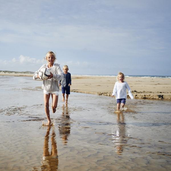 Kids running on Saltum Beach in North Jutland