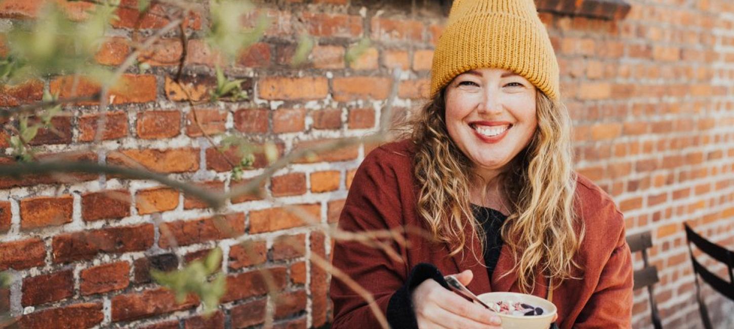 A woman having breakfast outside in Copenhagen, Denmark