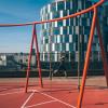 A lady running at the rooftop playground Konditaget Lüders in Nordhavn, Copenhagen, Denmark