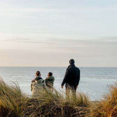 Family looking to the sea at Blåvand beach, West Jutland