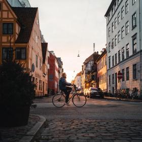 Girl biking in the neighbourhood of Christianshavn in Copenhagen